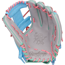 The Rawlings Heart of the Hide 12" Fastpitch Glove (PRO716SB-2GCB) features gray leather, pink and teal laces, blue accents, and displays the iconic Rawlings logo and Heart of the Hide branding inside the open palm.