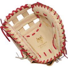 The Rawlings Heart of the Hide 33" Kinzie Hansen K9 Fastpitch Catcher's Mitt (PROCM33FP-24CS) features tan leather with red lacing, a bulldog logo, an open web design, and PROSPECT 2409 and WANTSEEN on the palm for top performance.