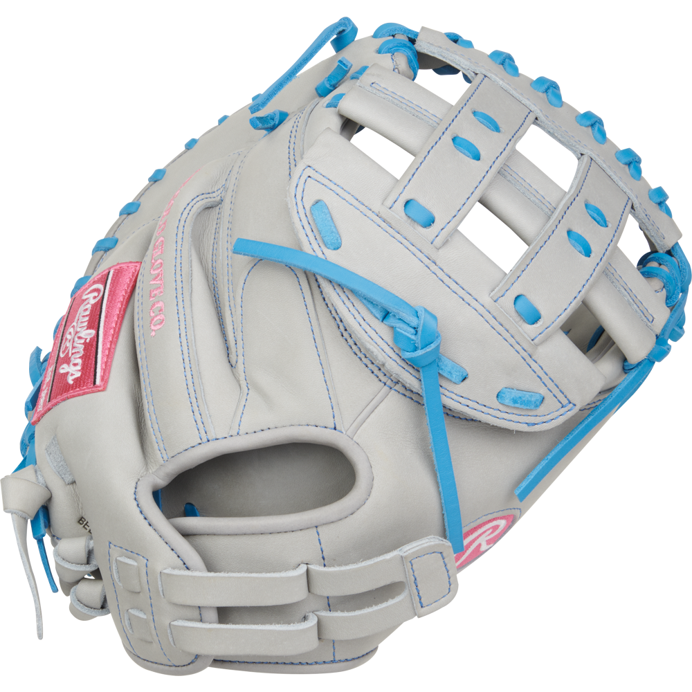 A close-up of the Rawlings Heart of the Hide 33" Fastpitch Catcher's Mitt (PROCM33FP-24GCB) in gray leather with blue laces and trim, featuring a pink Rawlings logo patch and a webbed pocket for catching.