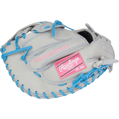 The Rawlings Heart of the Hide 33" Fastpitch Catcher's Mitt (PROCM33FP-24GCB) features a light gray design with blue laces, pink accents, and a patch reading THE GOLD GLOVE CO. Est. 1887.