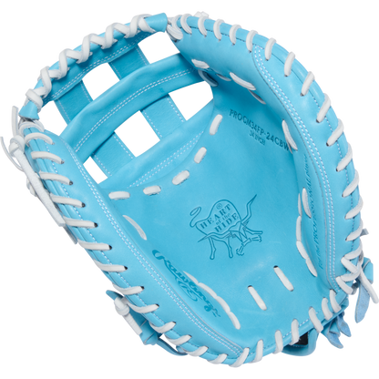 The Rawlings Heart of the Hide 34" Fastpitch Catcher's Mitt (PROCM34FP-24CBW) features a light blue design with white laces and an embossed logo in the palm area.