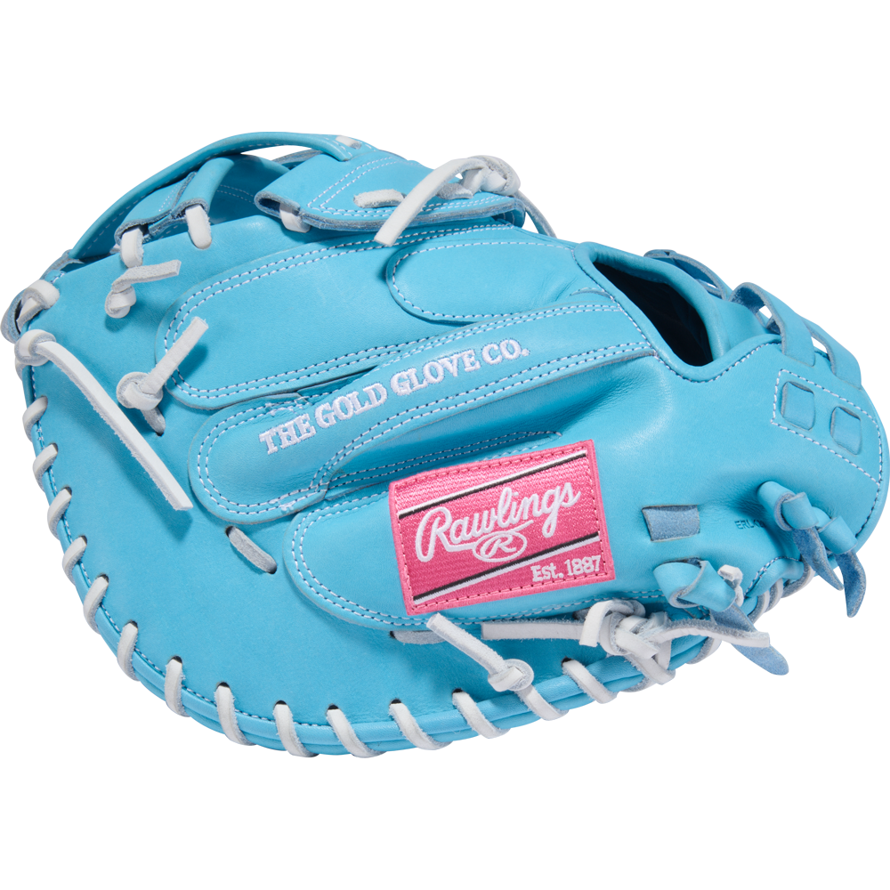 The Rawlings Heart of the Hide 34" Fastpitch Catcher's Mitt (PROCM34FP-24CBW) is light blue with white laces, a pink “Rawlings” and “Est. 1887” patch, plus “THE GOLD GLOVE CO.” embroidered in white.