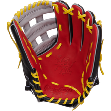 The Rawlings Heart of the Hide 12.25" Baseball Glove (PROKB17SB) features a red, black, and yellow design with yellow laces and white accents, shown palm up against a white background. Inspired by Kris Bryant for pro-level play.