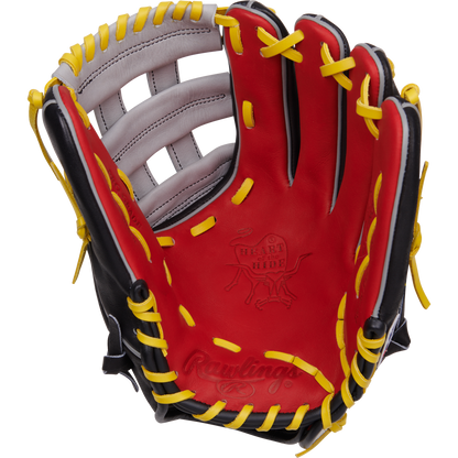 The Rawlings Heart of the Hide 12.25" Baseball Glove (PROKB17SB) features a red, black, and yellow design with yellow laces and white accents, shown palm up against a white background. Inspired by Kris Bryant for pro-level play.