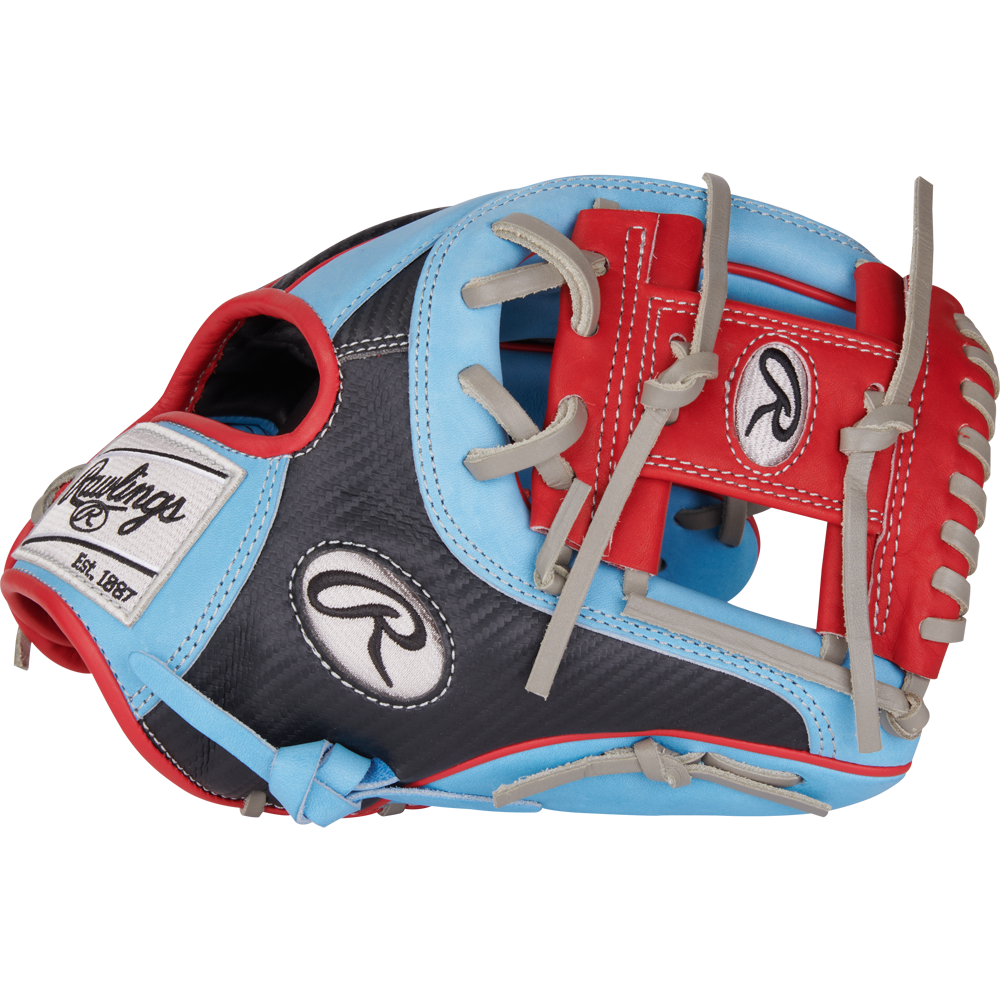 The Rawlings Heart of the Hide 11.5" Baseball Glove (PROR204-2CBS) features a blend of light blue, red, gray, and black with gray laces, bold red webbing, and white Rawlings logos on the wrist strap and thumb.
