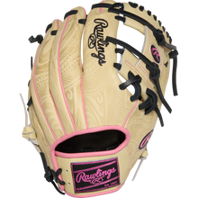 The Rawlings Heart of the Hide 11.5" Baseball Glove (PROR204-2CPB) features a beige design with pink and black accents, detailed engravings, and bold Rawlings branding on the back and wrist strap.
