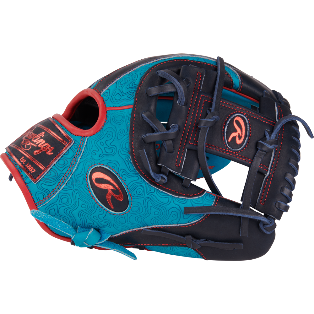 The Rawlings Heart of the Hide 11.5" Color Sync Baseball Glove (PROR204-2TE) features blue and navy leather with red stitching, decorative patterns, and prominent Rawlings logos on the thumb and wrist for standout style.