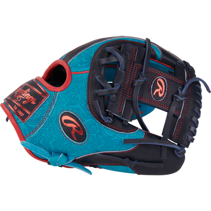 The Rawlings Heart of the Hide 11.5" Color Sync Baseball Glove (PROR204-2TE) features blue and navy leather with red stitching, decorative patterns, and prominent Rawlings logos on the thumb and wrist for standout style.