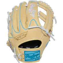 A tan Rawlings Heart of the Hide 11.5″ baseball glove (model PROR204W-1CCB) features white laces, light blue accents, “Wing Tip” text on the thumb, and a blue Rawlings patch near the wrist.