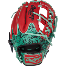 The Rawlings Heart of the Hide 11.5" Color Sync Baseball Glove (PROR204W-32BS) features red and teal colors, teal laces, stylish teal and black patterns, and signature Rawlings branding on the wrist strap and back.