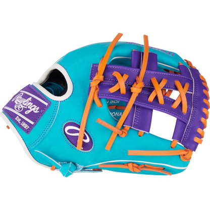 The Rawlings Heart of the Hide 11.75" Baseball Glove (PROR205-32TEP) features bright turquoise leather, orange laces, purple accents, white stitching, and a Rawlings Est. 1887 patch on the side.
