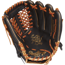 A Rawlings Heart of the Hide 11.75" Baseball Glove (PROR205-4DS) in black and brown, shown open to display its leather interior, gold stitching, and the engraved Heart of the Hide logo on the palm.
