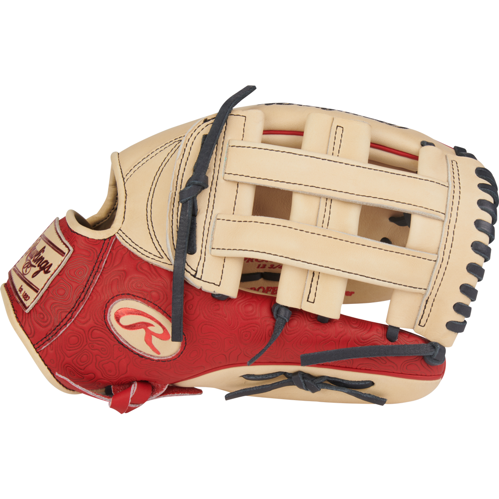 The Rawlings Heart of the Hide 12.75" Baseball Glove (PROR3039-6CS) features a tan and red design, black laces, a woven web, embossed red palm, and a logo patch on the wrist.