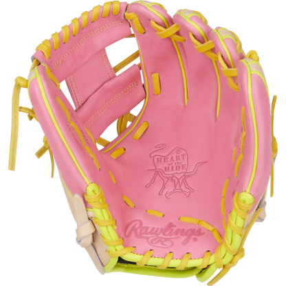 The Rawlings Heart of the Hide 11.25" Color Sync Baseball Glove (PROR312U-2P) is pink with yellow lacing, featuring the ColorSync Rawlings logo and Heart of the Hide stamp on the palm.