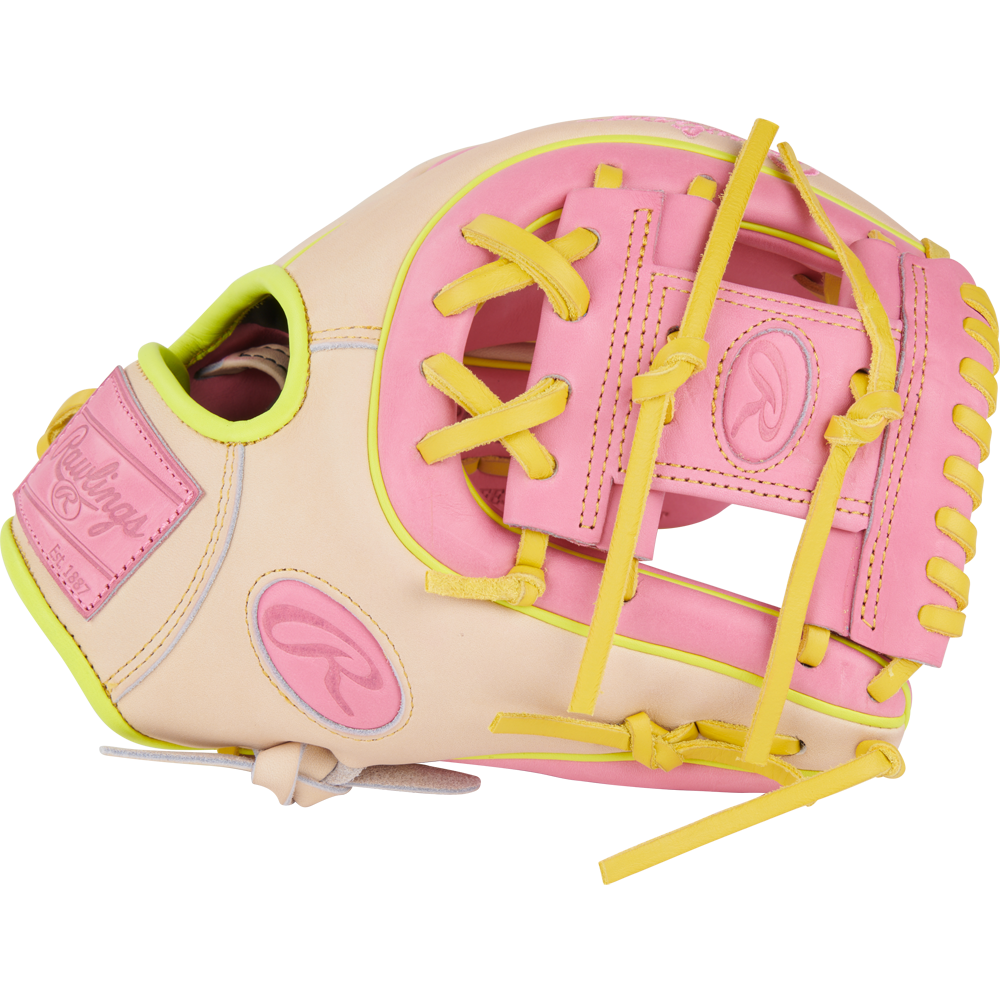 The Rawlings Heart of the Hide 11.25" Color Sync Baseball Glove (PROR312U-2P) features a beige design with pink and yellow laces and accents, plus the signature Rawlings logo.