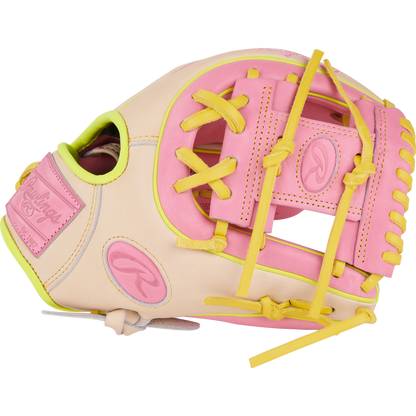 The Rawlings Heart of the Hide 11.25" Color Sync Baseball Glove (PROR312U-2P) features a beige design with pink and yellow laces and accents, plus the signature Rawlings logo.