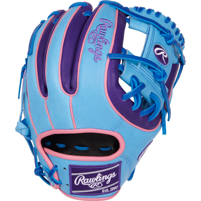 The Rawlings Heart of the Hide 11.5" Color Sync Baseball Glove (PROR314-2CBPU) features blue, purple, and pink colors with bright blue laces and the Rawlings logo on the wrist patch and thumb.