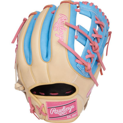 The Rawlings Heart of the Hide 11.5" Baseball Glove (PROR314-32CCB) features tan leather with blue and pink accents, pink laces, a pink Rawlings logo, and “Est. 1887” on the wrist—ideal for infielders.