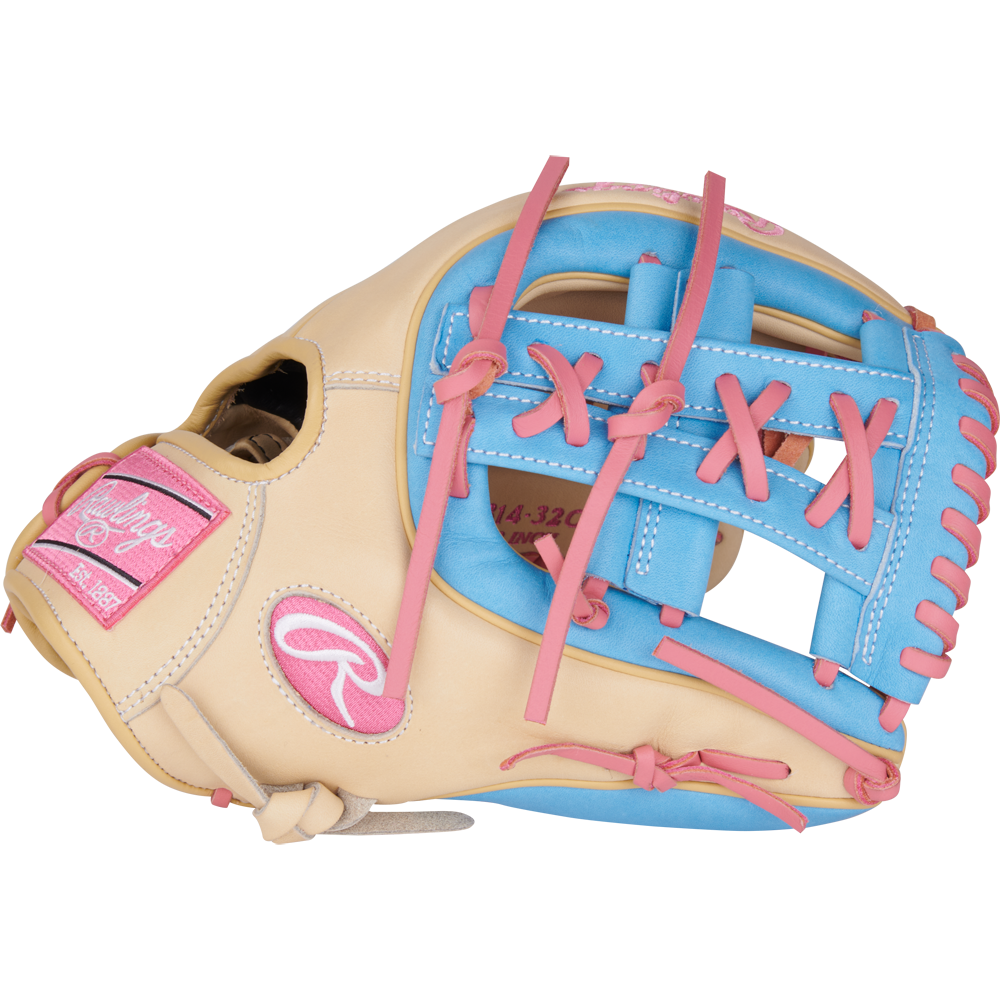 The Rawlings Heart of the Hide 11.5" Baseball Glove (PROR314-32CCB) features a beige design with pink laces, blue trim, and a pink logo patch. It's pictured on a plain white background.