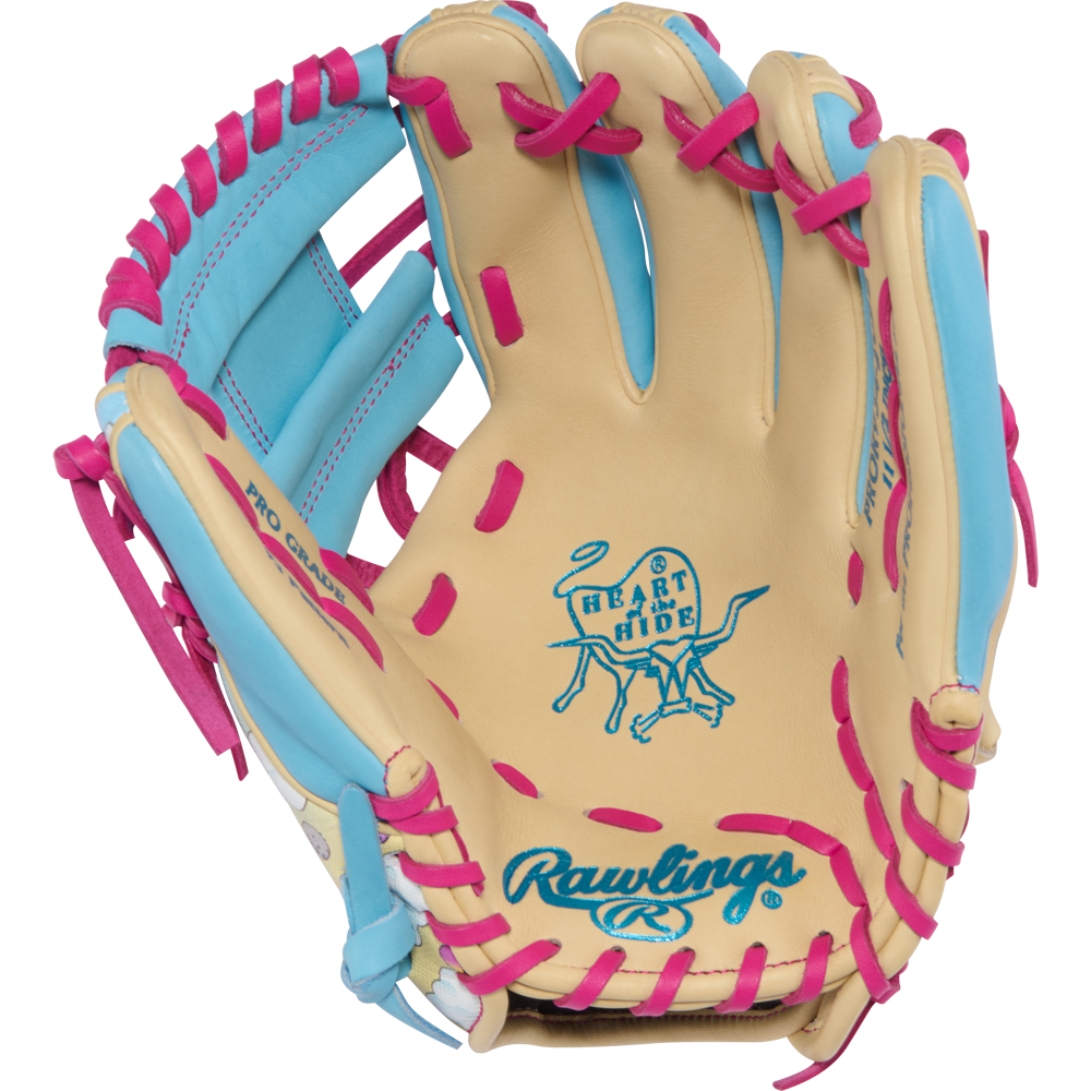 The Rawlings Heart of the Hide Icon Fest 11.5" Baseball Glove (PROR934-2CBE) features tan steerhide leather with blue accents, pink lacing, and displays the iconic Heart of the Hide logo plus Rawlings branding on the palm.