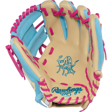 The Rawlings Heart of the Hide Icon Fest 11.5" Baseball Glove (PROR934-2CBE) features tan steerhide leather with blue accents, pink lacing, and displays the iconic Heart of the Hide logo plus Rawlings branding on the palm.