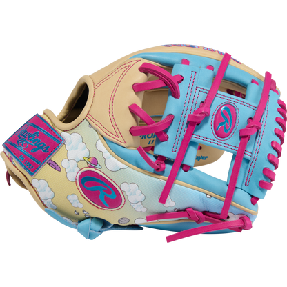 The Rawlings Heart of the Hide Icon Fest 11.5" Baseball Glove (PROR934-2CBE) features premium steerhide leather in cream, blue, and pink with cloud patterns, pink laces, and Heart of the Hide logos on the wrist strap and thumb.