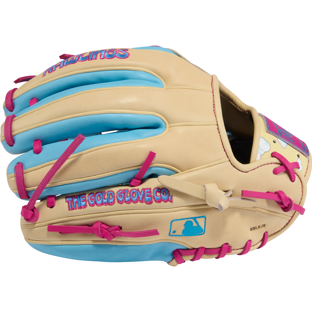 The Rawlings Heart of the Hide Icon Fest 11.5" Baseball Glove (PROR934-2CBE) features a tan design with bright blue and pink accents, crafted from premium steerhide leather, and displays the Rawlings logo and “THE GOLD GLOVE CO.” on the side.
