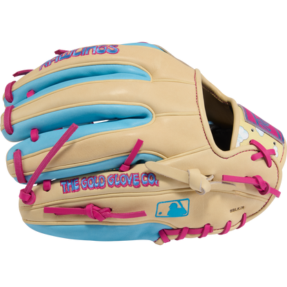 The Rawlings Heart of the Hide Icon Fest 11.5" Baseball Glove (PROR934-2CBE) features a tan design with bright blue and pink accents, crafted from premium steerhide leather, and displays the Rawlings logo and “THE GOLD GLOVE CO.” on the side.