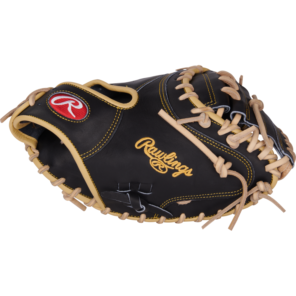 The Rawlings Heart of the Hide 34" Adley Rutschman Baseball Catcher's Mitt (PRORAR35) features black and tan leather with yellow stitching, tan laces, and a red and white Rawlings logo on the thumb.
