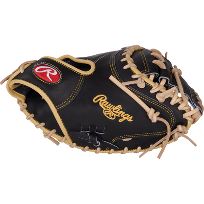 The Rawlings Heart of the Hide 34" Adley Rutschman Baseball Catcher's Mitt (PRORAR35) features black and tan leather with yellow stitching, tan laces, and a red and white Rawlings logo on the thumb.