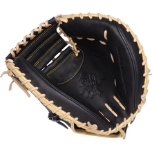 A Rawlings Heart of the Hide 34" Adley Rutschman catcher's mitt (PRORAR35) in black with light tan laces, yellow stitching, and an embossed palm logo is displayed on a plain white background.