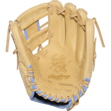 A Rawlings Heart of the Hide 11.5″ Baseball Glove (model PRORB734-2XC), in tan with light blue accents, is shown open and facing upward.