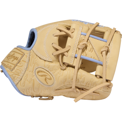 A side view of the Rawlings Heart of the Hide 11.5″ Baseball Glove (PRORB734-2XC) from Rawlings, featuring a tan and light blue design with embossed patterns, visible laces and stitching details, and prominent Rawlings logos.