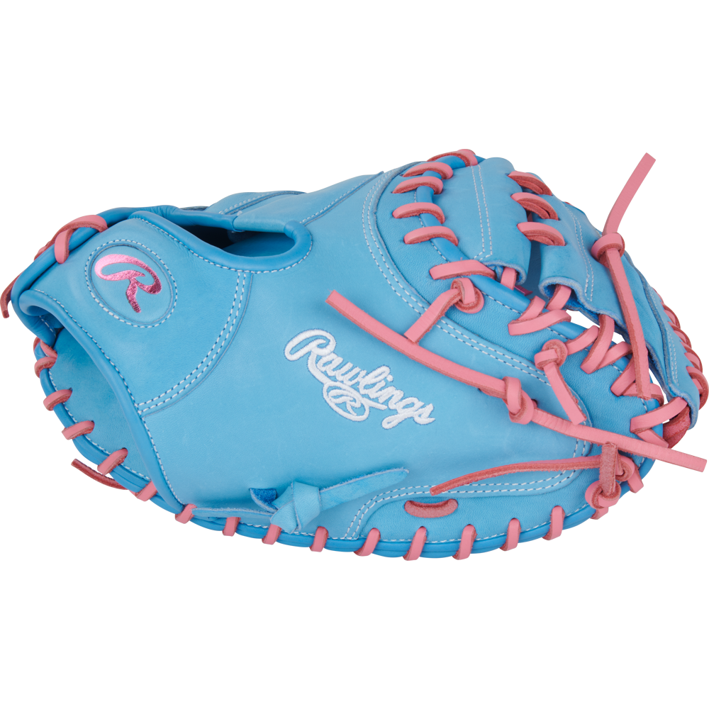 A light blue Rawlings Heart of the Hide 33" baseball catcher's mitt (PRORCM33-23CBP) with pink laces and stitching, featuring the Rawlings logo embroidered in white on the side.