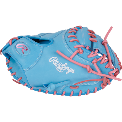 A light blue Rawlings Heart of the Hide 33" baseball catcher's mitt (PRORCM33-23CBP) with pink laces and stitching, featuring the Rawlings logo embroidered in white on the side.