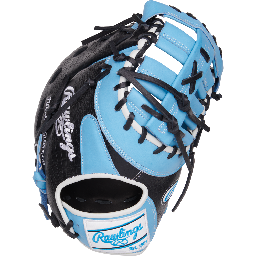 The Rawlings Heart of the Hide 13" First Base Mitt (PRORDCT-10CB) features a black and light blue design with white accents, black laces, and the Rawlings logo on the wrist strap.