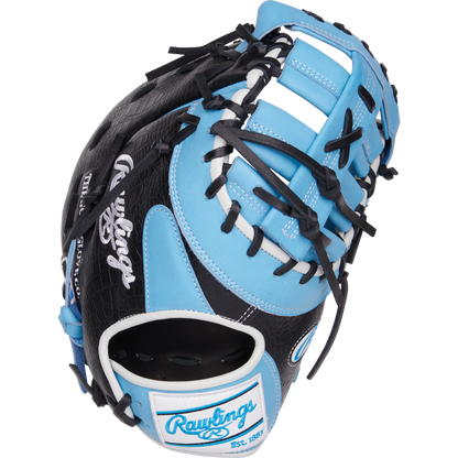 The Rawlings Heart of the Hide 13" First Base Mitt (PRORDCT-10CB) features a black and light blue design with white accents, black laces, and the Rawlings logo on the wrist strap.