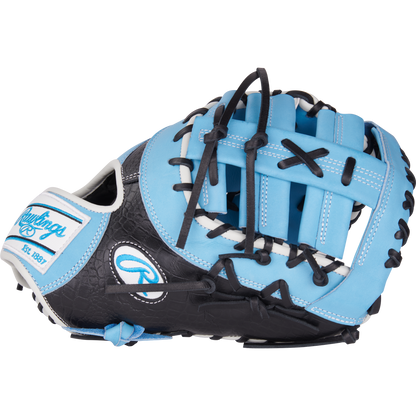 The Rawlings Heart of the Hide 13" First Base Mitt (PRORDCT-10CB) features a blue and black design with black laces, white accents, decorative stitching, and the Rawlings logo.