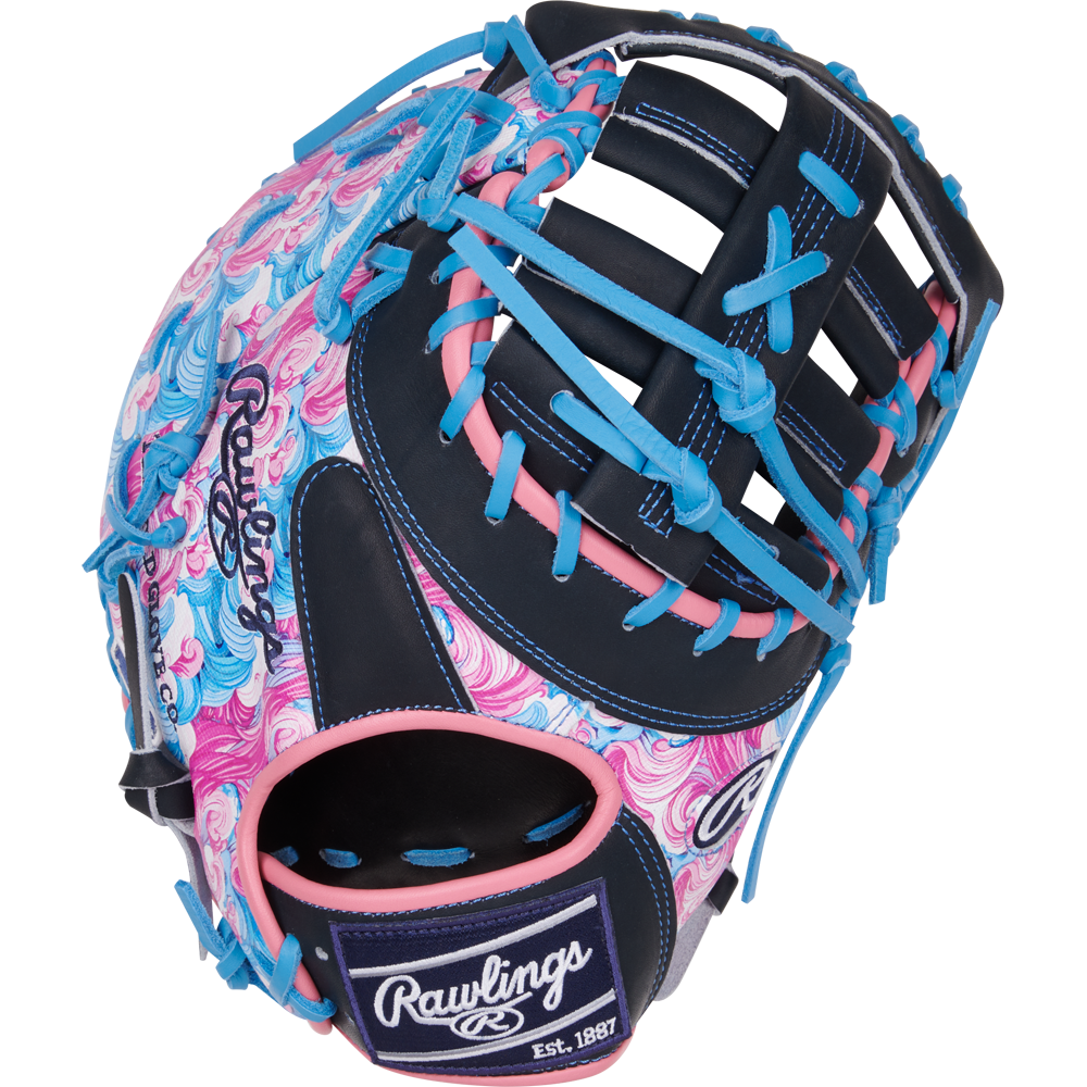 The Rawlings Heart of the Hide 13" ColorSync First Base Mitt (PRORDCT-10NSS) features swirling pink, blue, and white patterns with navy webbing and blue laces. The Rawlings logo appears on the thumb and wrist strap.