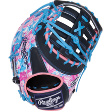 The Rawlings Heart of the Hide 13" ColorSync First Base Mitt (PRORDCT-10NSS) features swirling pink, blue, and white patterns with navy webbing and blue laces. The Rawlings logo appears on the thumb and wrist strap.