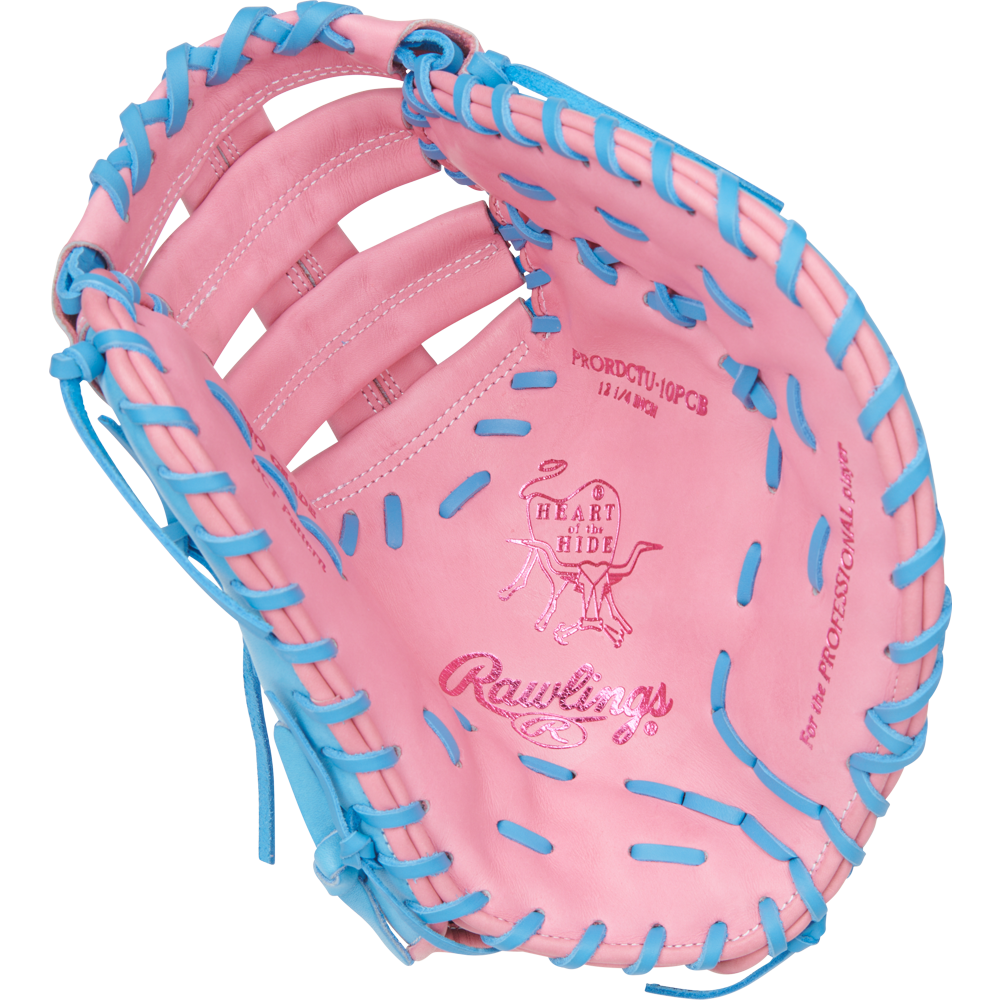 The Rawlings Heart of the Hide 12.25" First Base Mitt (PRORDCTU-10PCB) features a pink design with blue lacing, ContoUR Fit, and embossed logos on the palm—combining standout style and renowned Rawlings performance.