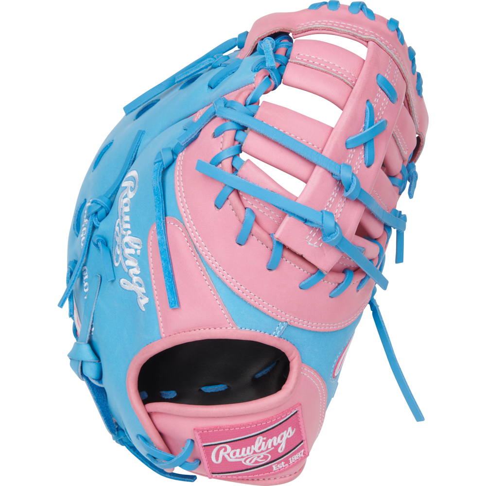 A Rawlings Heart of the Hide 12.25" First Base Mitt (PRORDCTU-10PCB) features a pink and blue design with blue laces and white branding, displayed against a plain white background.