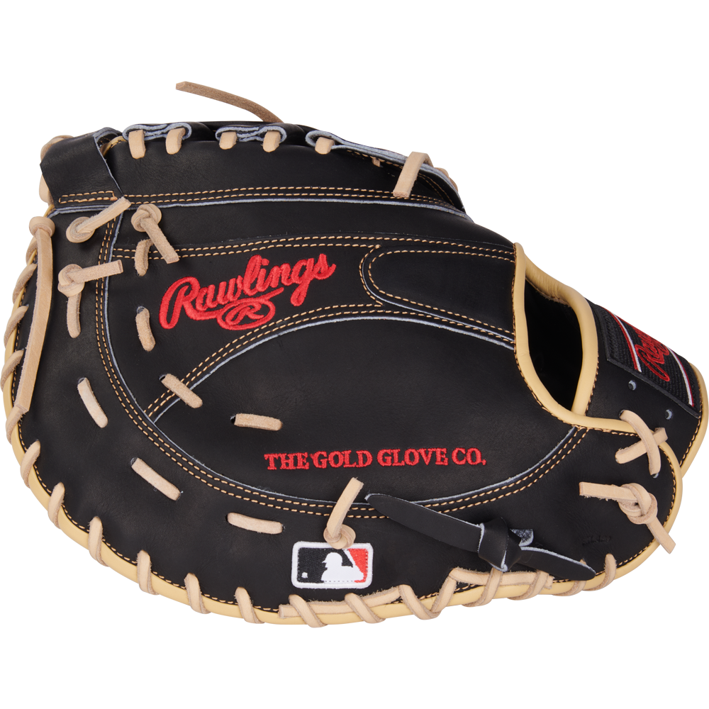 A black Rawlings Heart of the Hide 12.5" first base mitt (PRORFM18-17BCS) features tan laces, red embroidered Rawlings and THE GOLD GLOVE CO. text, and an MLB logo patch on the wrist area.