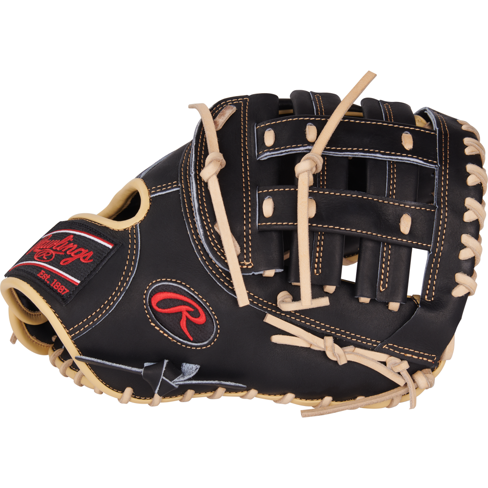 The Rawlings Heart of the Hide 12.5" First Base Mitt (PRORFM18-17BCS) is black with beige laces, a red and black Rawlings logo on the wrist strap, and classic basket-style webbing.
