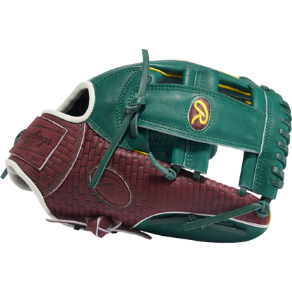 The Rawlings Heart of the Hide 11.75" Baseball Glove (PRORNP5-13DG) features green and maroon leather, a woven maroon pattern, and yellow logo accents, perfect for infielders.