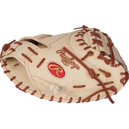 The Rawlings Heart of the Hide 34" Yadier Molina Catcher's Mitt (PRORYM4C) features a tan design with brown lacing and a red Rawlings logo, shown at an angle to highlight the glove’s pocket and detailed stitching.