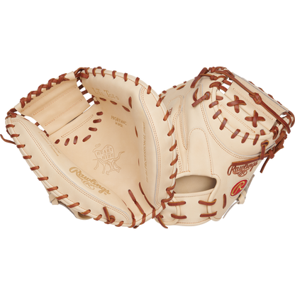 The Rawlings Heart of the Hide 34" Yadier Molina Catcher's Mitt (PRORYM4C) is shown open, highlighting its tan and brown premium leather, detailed lacing, intricate stitching, and embossed branding.