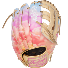 The Rawlings Heart of the Hide 12" Sierra Romero Game Model Fastpitch Glove (PROSR32C) features a pastel sky design with pink and orange clouds, tan laces, and a white embroidered Rawlings logo on the back.