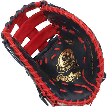 A close-up of the Rawlings Pro Preferred 13" Vladimir Guerrero JR Gameday First Base Mitt (PROSVG27), featuring red lacing and trim, dark blue leather, and gold branding on the palm.