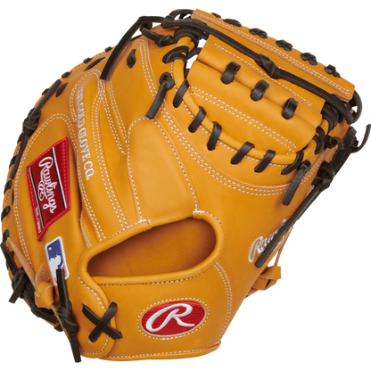 The Rawlings Heart of the Hide 33" Catcher's Mitt (RPROTCM33T) features a tan design with black laces, red and white Rawlings logos, and a white-stitched MLB logo on the wrist.